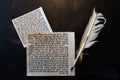 Mezuzah parchments made from animal skin with the full text of the Shema Yisrael Jewish prayer in Hebrew and the feather quill