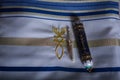 Mezuzah scrolls on a beautiful white tallit