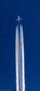 Boeing 747 jumbo jet passing by at high altitude, leaving contrails behind. Royalty Free Stock Photo