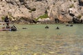 A group of divers comes out from Mediterranean sea near cliffs in Gozo in Malta Royalty Free Stock Photo