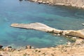 Panorama of Gnejna bay, the most beautiful beach in Malta at sunset with beautiful colorful sky and golden rocks