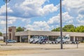 MHC building with trucks parked and blue sky with clouds