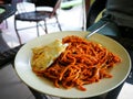 Mi goreng or mee goreng mamak, Indonesian and Malaysian cuisine, spicy fried noodles in a plate at a restaurant. Royalty Free Stock Photo