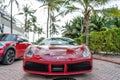 Miami Beach, Florida USA - April 18, 2021: red Ferrari 488 GTB with palms, front view