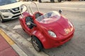 Miami Beach, Florida USA - April 14, 2021: red scootcoupe moped, corner view. tree-wheel scooter