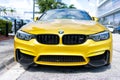 Miami Beach, Florida USA - April 15, 2021: yellow bmw m4, front view low angle. luxury sportcar Royalty Free Stock Photo