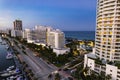 Miami Beach, Florida, USA - Evening aerial of luxury condominiums and hotels along Indian Creek Driver spanning from
