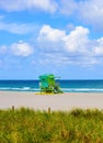 Miami Beach with lifeguard tower and coastline with colorful cloud and blue sky. Sandy Tropical Scene. Royalty Free Stock Photo
