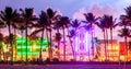 Miami Beach Ocean Drive hotels and restaurants at sunset. City skyline with palm trees at night. Art deco nightlife on