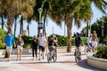 Miami Beach summer crowds walking and riding bike Ocean Drive