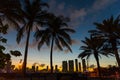 Miami beach at sunset with palm trees on the foreground Royalty Free Stock Photo