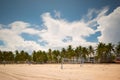 Miami Beach volleyball net courts on the sand. Long exposure photo shot with motion blur imn palm trees and clouds Royalty Free Stock Photo
