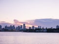 Miami city skyline panorama at dusk with urban skyscrapers and bridge over sea with reflection Royalty Free Stock Photo