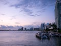 Miami city skyline panorama at dusk with urban skyscrapers and bridge over sea with reflection Royalty Free Stock Photo