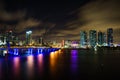 Miami city skyline panorama at dusk with urban skyscrapers and bridge over sea with reflection Royalty Free Stock Photo