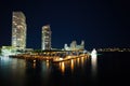 Miami city skyline panorama at dusk with urban skyscrapers and bridge over sea with reflection. Night in Miami. Royalty Free Stock Photo