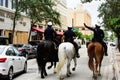 Miami Downtown, FL, USA - JUNE 4, 2020: Three horses with equestrians in a police form, the rear view. American Police. Royalty Free Stock Photo