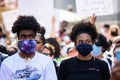 Miami Downtown, FL, USA - MAY 31, 2020: A couple of black masked people. Demonstration against racism. People of