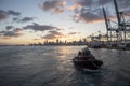 Miami, Florida, USA - evening in the sea port, tug boat assisting to cargo ship. Royalty Free Stock Photo