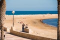 MIAMI PLATJA, SPAIN - APRIL 24, 2017: A man is taking pictures of a woman on the embankment. Copy space. Royalty Free Stock Photo