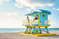 Miami south beach Florida, couple by lifeguard hut during Sunrise Miami Beach, men and woman on the beach Royalty Free Stock Photo