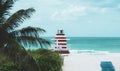 Miami South Beach lifeguard tower and coastline with cloud and blue sky. Sandy Tropical Scene. Royalty Free Stock Photo