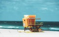 Miami South Beach lifeguard tower and coastline with cloud and blue sky. Sandy Tropical Scene. Royalty Free Stock Photo