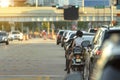 Miami street traffic with driving motorcycle and cars at urban intersection with traffic lights in Florida Royalty Free Stock Photo