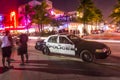 police car parks at the Ocean Drive along South Beach Miami in the historic Art Deco District with hotels, restaurant and bar by