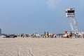 People enjoy south beach in Miami Beach at ocean drive. Police guards the tourists with a watchtower and policemen in car to avoit