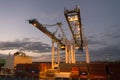 Miami, USA - March 01, 2016: containers in cargo port. Containers and cranes illuminated in dusk. Container ship