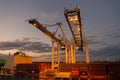 Miami, USA - March 01, 2016: containers in cargo port. Containers and cranes illuminated in dusk. Container ship