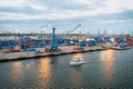 Miami, USA - March 01, 2016: maritime container port with cargo ship and cranes. Yacht float along sea port and terminal or dock. Royalty Free Stock Photo