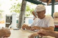 MIAMIA, FLORIDA - APRIL 29, 2015: Little Havana district in Miami and People playing Domino in Maximo Gomez Park Domino Park