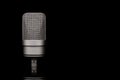 Mic - Close-up of professional condenser microphone on a black isolated background Royalty Free Stock Photo