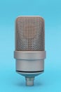 Mic - Close-up of a professional large-diaphragm condenser microphone with blue background Royalty Free Stock Photo