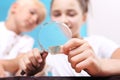 Mica. Two children, a girl and a boy watching through a magnifying glass stones from his collection of rocks. Royalty Free Stock Photo