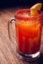 Michelada beer with tomato juice. Clamato with beer on wooden table. Mexican drink. Mexican food. Royalty Free Stock Photo