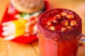 Michelada beer with tomato juice. Clamato with beer on wooden table. Mexican drink. Michelada beer with tomato juice, shrimps Royalty Free Stock Photo