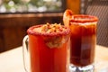 Michelada beer with tomato juice. Clamato with beer on wooden table. Mexican drink. Michelada beer with tomato juice, shrimps Royalty Free Stock Photo