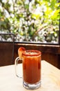 Michelada beer with tomato juice. Clamato with beer on wooden table. Mexican drink. Michelada beer with tomato juice, shrimps. Royalty Free Stock Photo