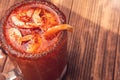 Michelada beer with tomato juice and shrimp. Clamato with beer on wooden table. Mexican drink. Vertical shot. Mexican food Royalty Free Stock Photo