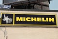 tor, canada - august 2, 2023: michelin logo horizontal rectangle sign with white tire mascot on building. p