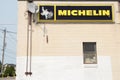 tor, canada - august 2, 2023: michelin logo horizontal rectangle sign with white tire mascot on building. p