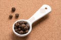 Whole Allspice Spilled from a Teaspoon Royalty Free Stock Photo