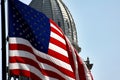 Michigan State Capitol building partially obscured by the American Flag in Lansing, the USA Royalty Free Stock Photo