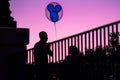 Mickey balloon and couple silhouette on sunset background at Epcot 164