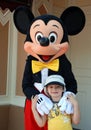 Mickey mouse and boy in disneyland Royalty Free Stock Photo
