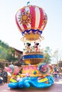 Mickey Mouse and Minnie Mouse riding in a float