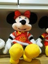 Mickey Mouse - shaped stuffed animals are displayed on the shelves, looking very cute